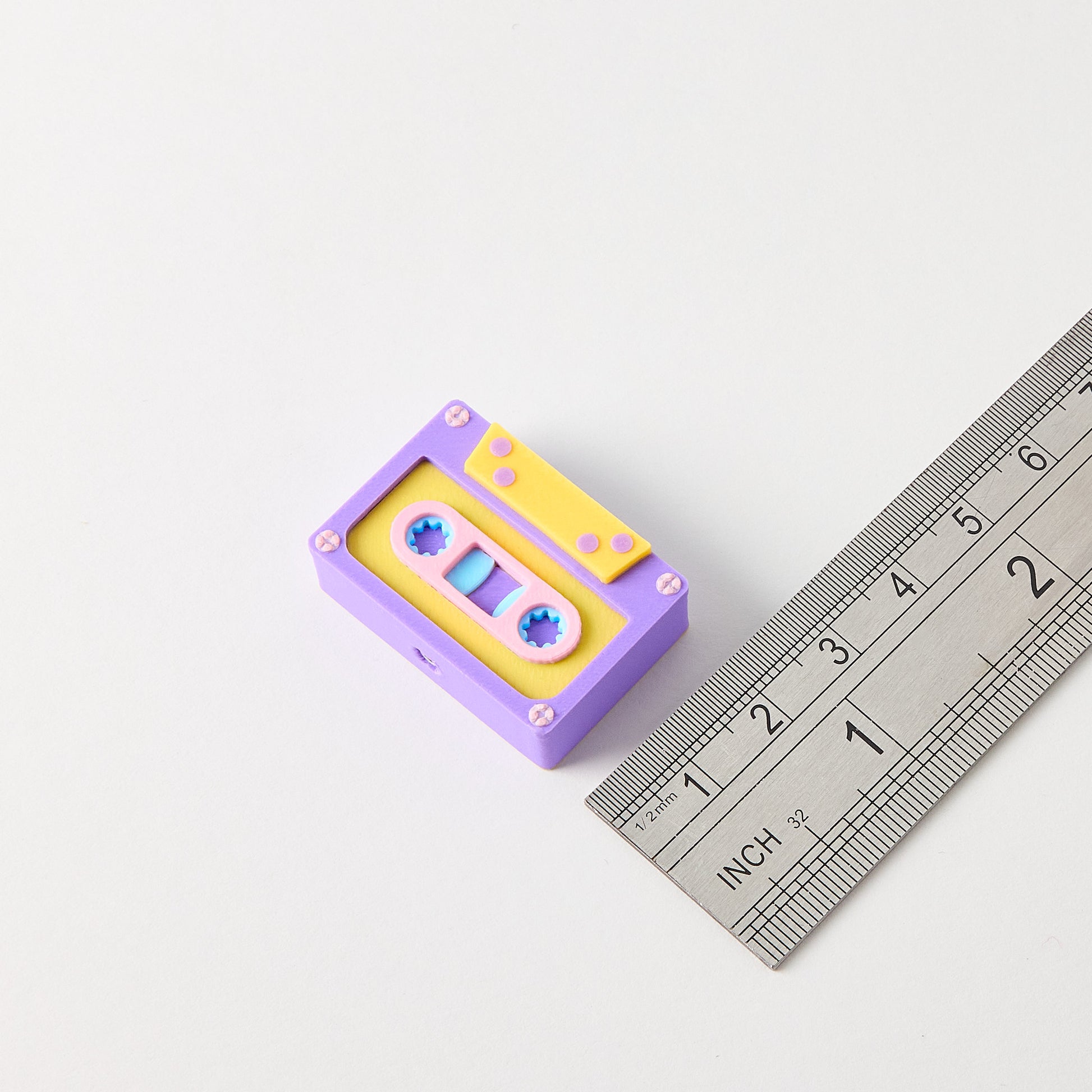 Cassette Topper size reference with ruler showing small batch hand finished guitar effects pedal footswitch accessory approximately 2.5cm tall