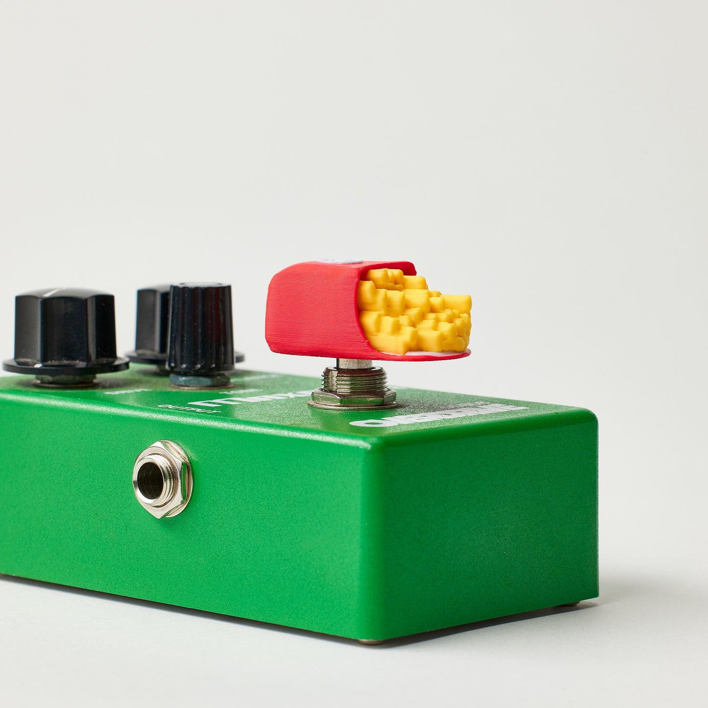 Fries Topper installed on guitar effects pedal footswitch