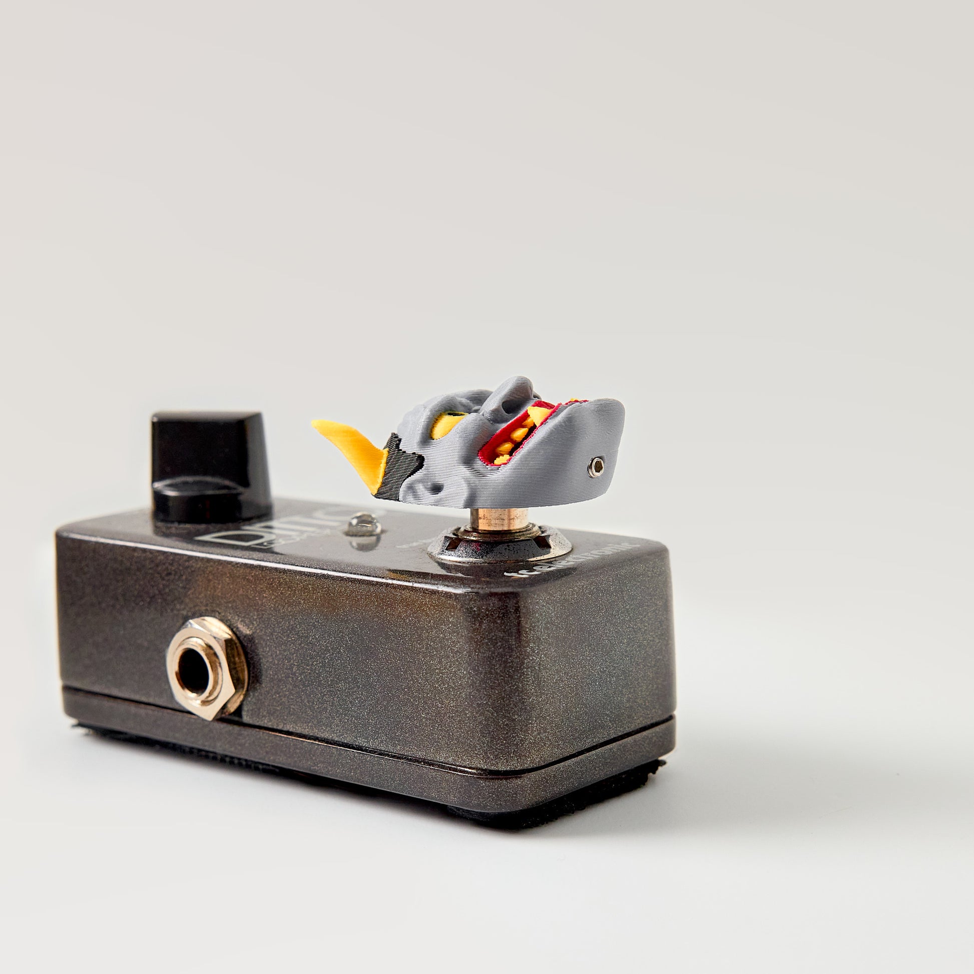 Hannya Topper — Japanese demon mask installed on guitar effects pedal low angle showing topper height and footswitch fit
