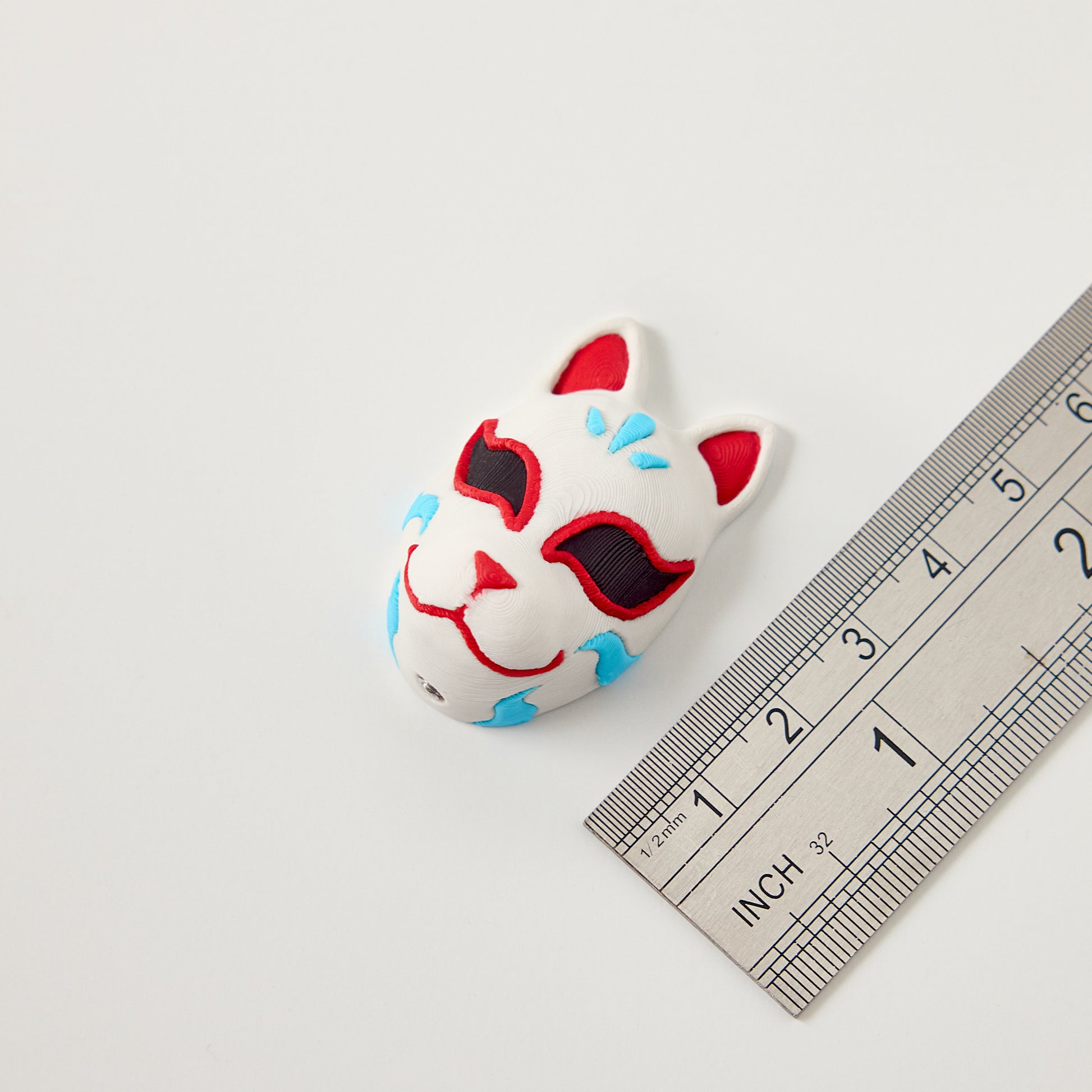 Kitsune Topper — size reference with ruler showing Japanese fox mask topper dimensions for 10mm guitar effects pedal footswitch