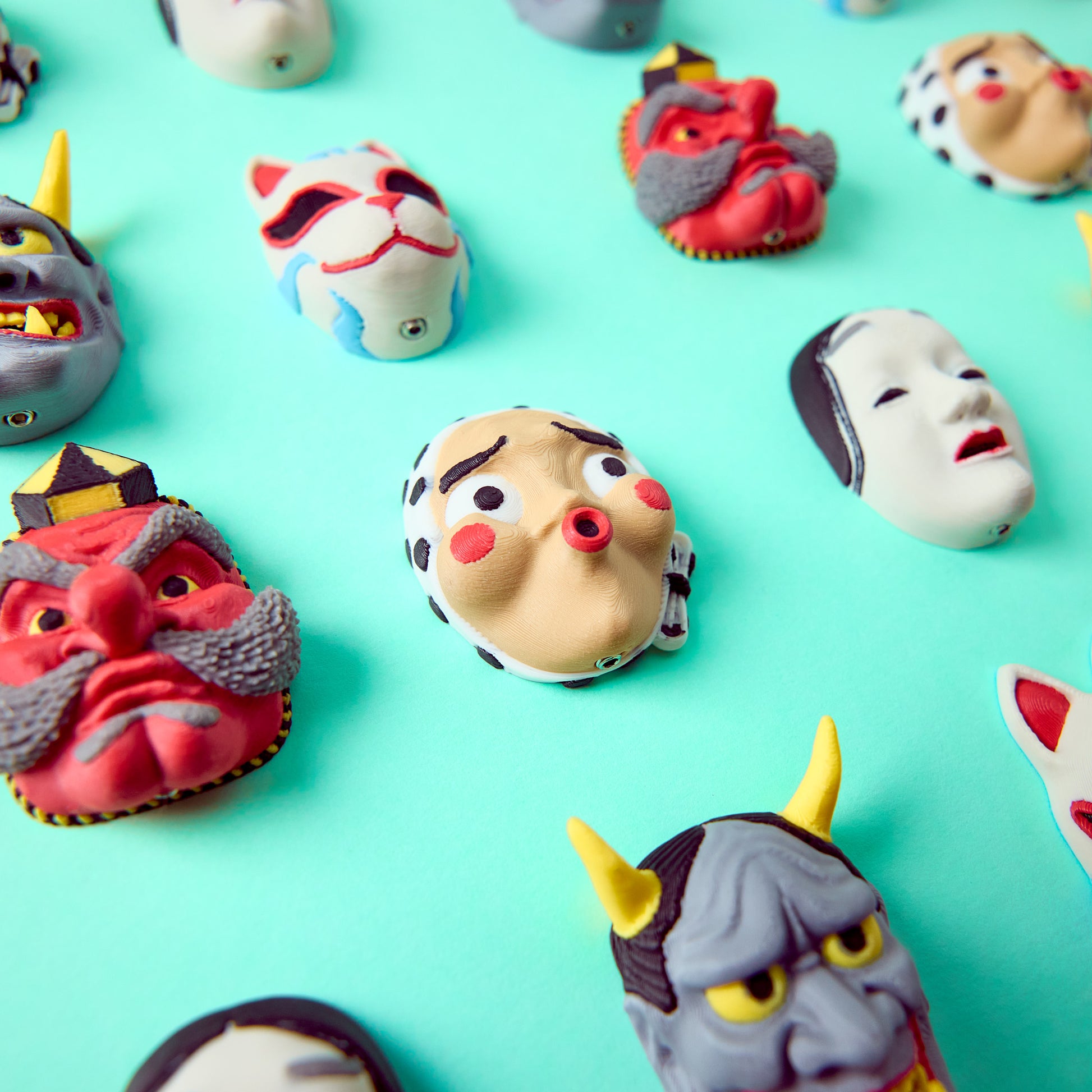 Mr.MojoFx Masks collection — Hannya Tengu Kitsune Koomote and Hyottoko in centre Japanese mask pedal switch toppers on teal background