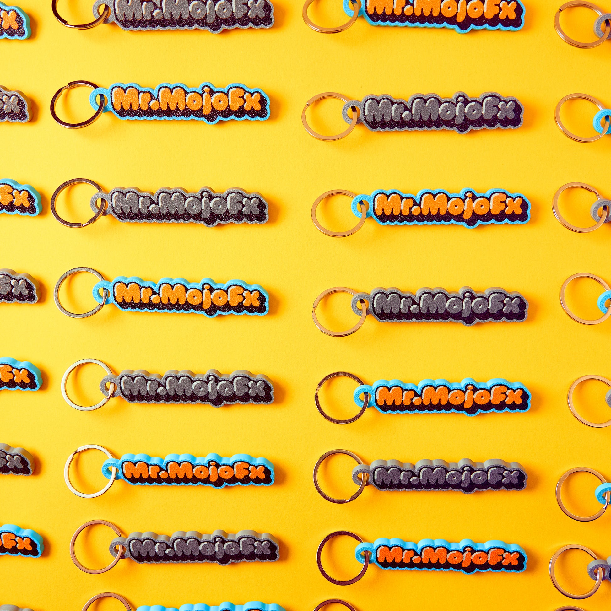 Mr.MojoFx Classic and Mono Key Fobs — branded repeat pattern on yellow background