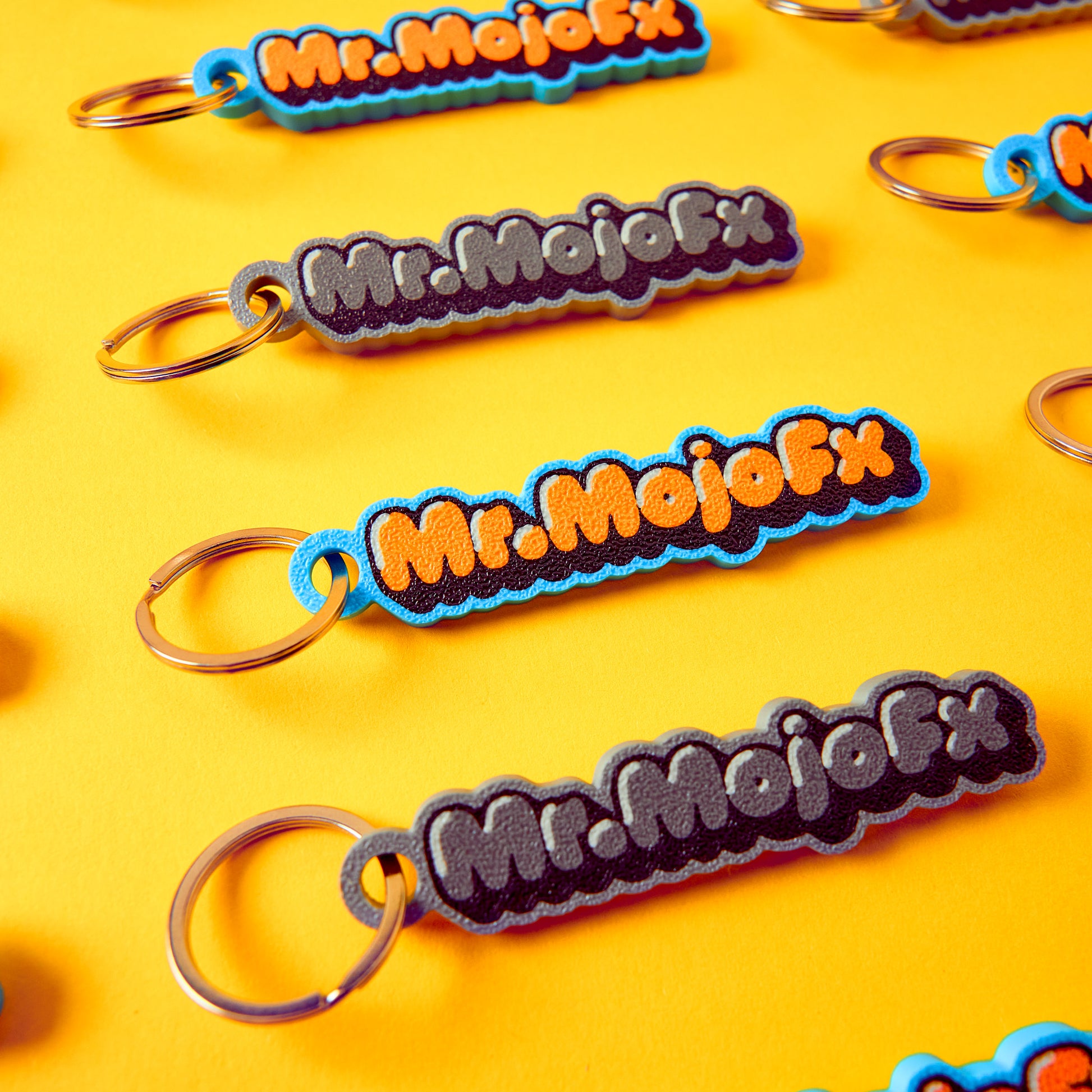 Mr.MojoFx Classic Key Fobs — multiple units on yellow background