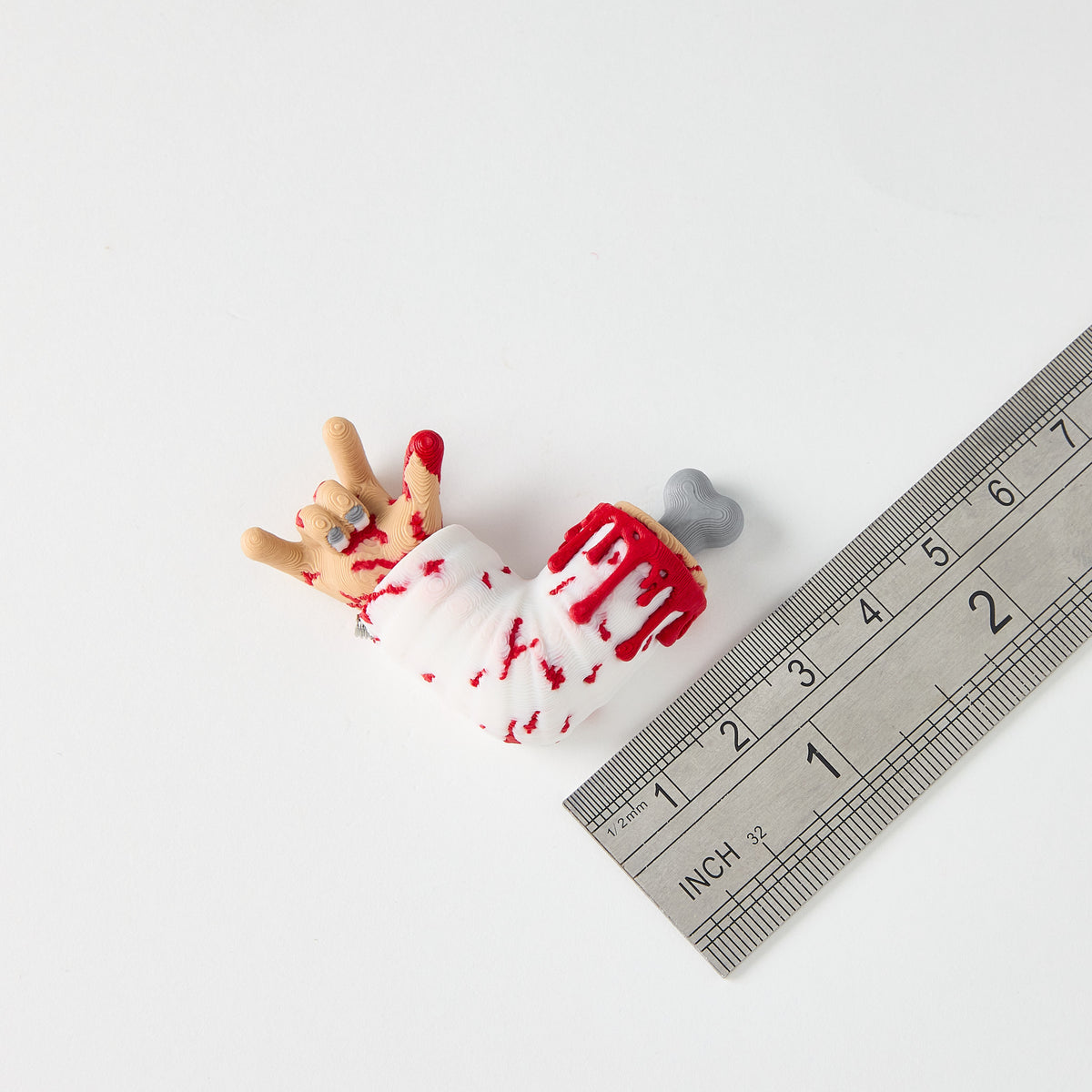 Mr. MojoFX Dogtown Broken Arm switch topper next to a ruler for size reference – approximately 4cm long, Dogtown Collection