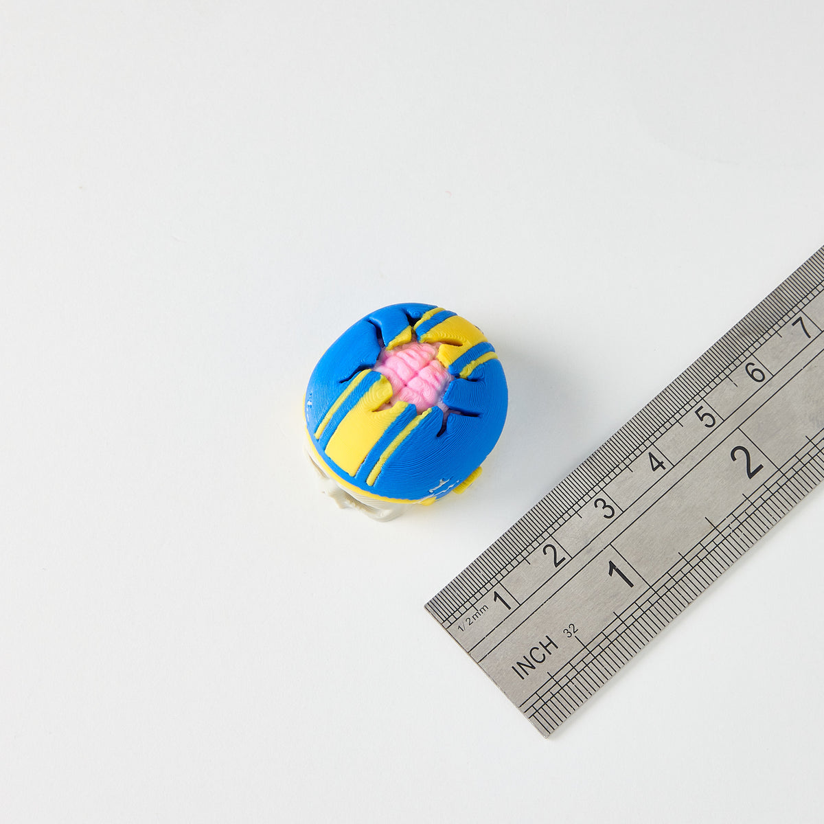 Mr.MojoFX Dogtown Skull Helmet switch topper next to a ruler for size reference – approximately 3cm long, Dogtown Collection