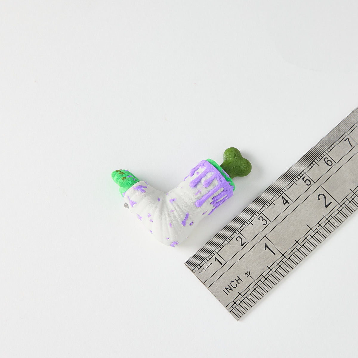Mr.MojoFX Dogtown Zombie Leg switch topper next to a ruler for size reference – approximately 4cm long, Dogtown Collection