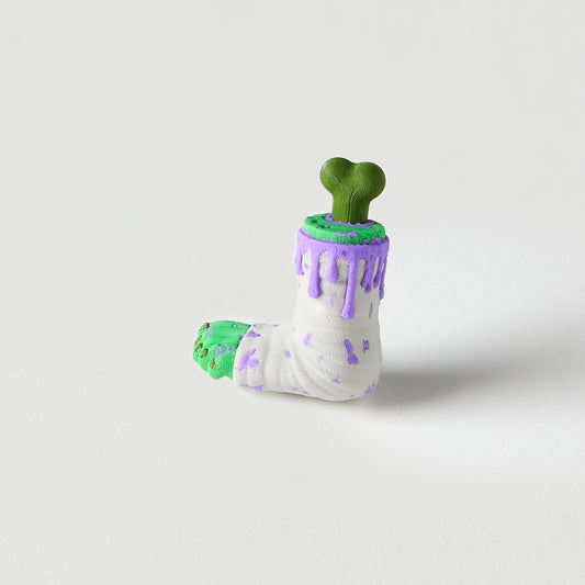 Mr.MojoFX Dogtown Zombie Leg guitar pedal switch topper – white cast dripping green and purple slime with a bone poking out the top