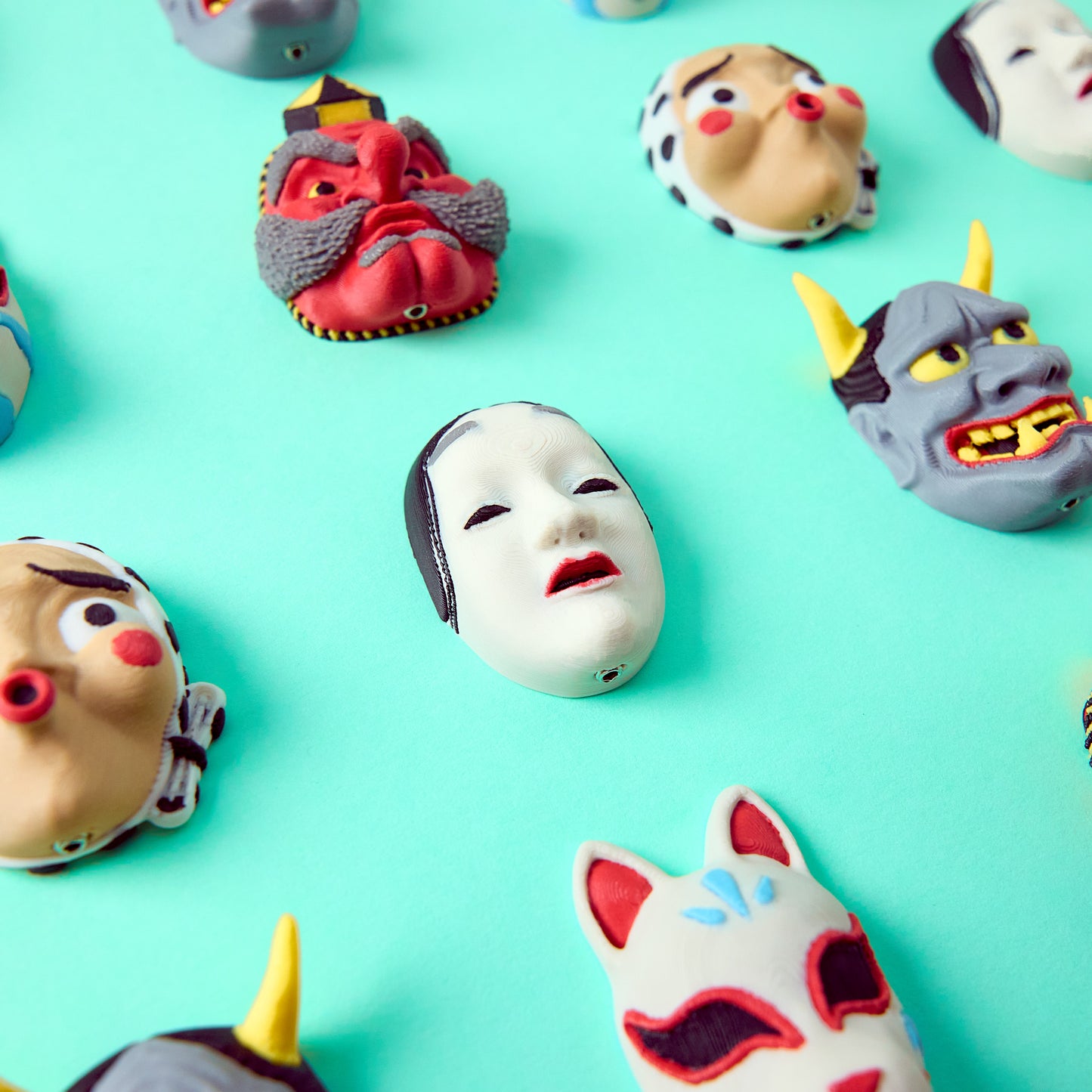 Mr.MojoFx Masks collection — Hannya Tengu Kitsune, Koomote in the centre and Hyottoko Japanese mask pedal switch toppers on teal background