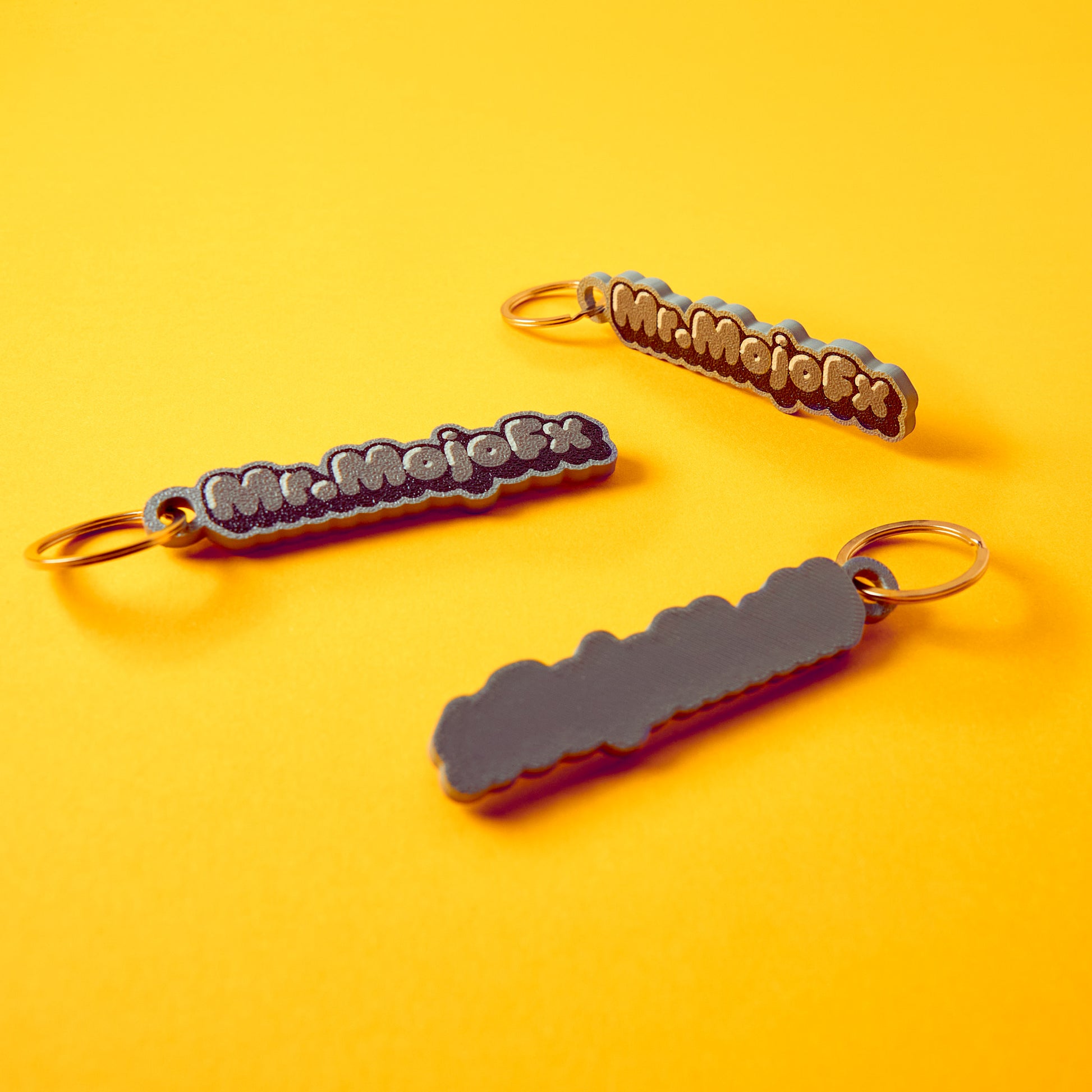 Mr.MojoFx Mono Key Fobs — multiple monochrome units on yellow background