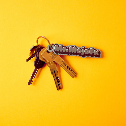 MrMojoFx Mono Key Fob attached to a house keyring on yellow background