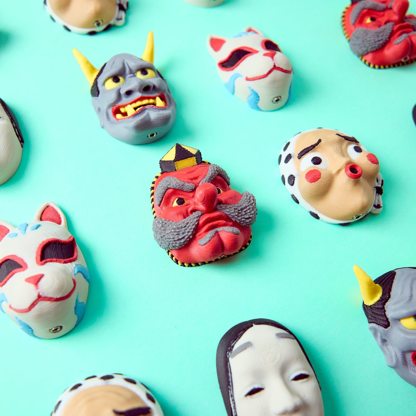 Tengu Topper in center of the entire Mr.MojoFx Masks collection — Hannya Tengu Kitsune Koomote and Hyottoko Japanese mask pedal switch toppers on teal background
