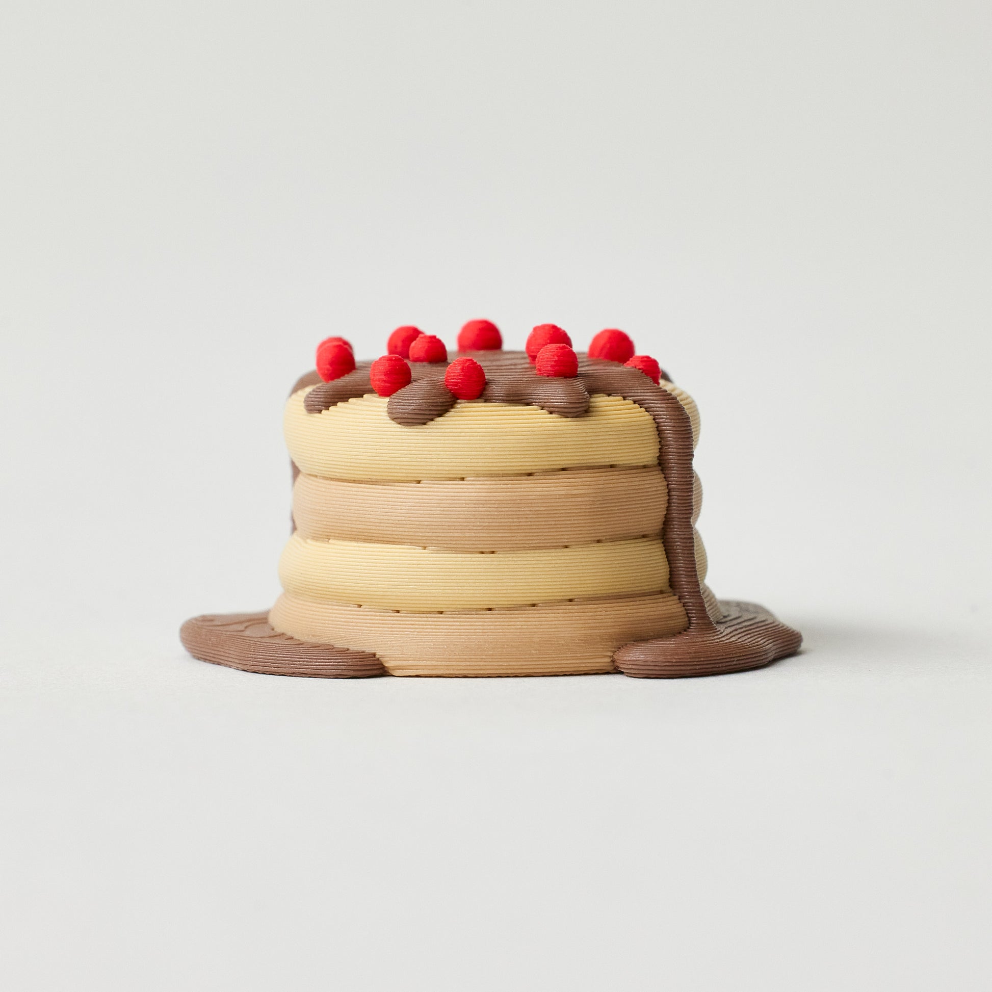 Pancake stack pedal topper angle view showing chocolate and cherry detail
