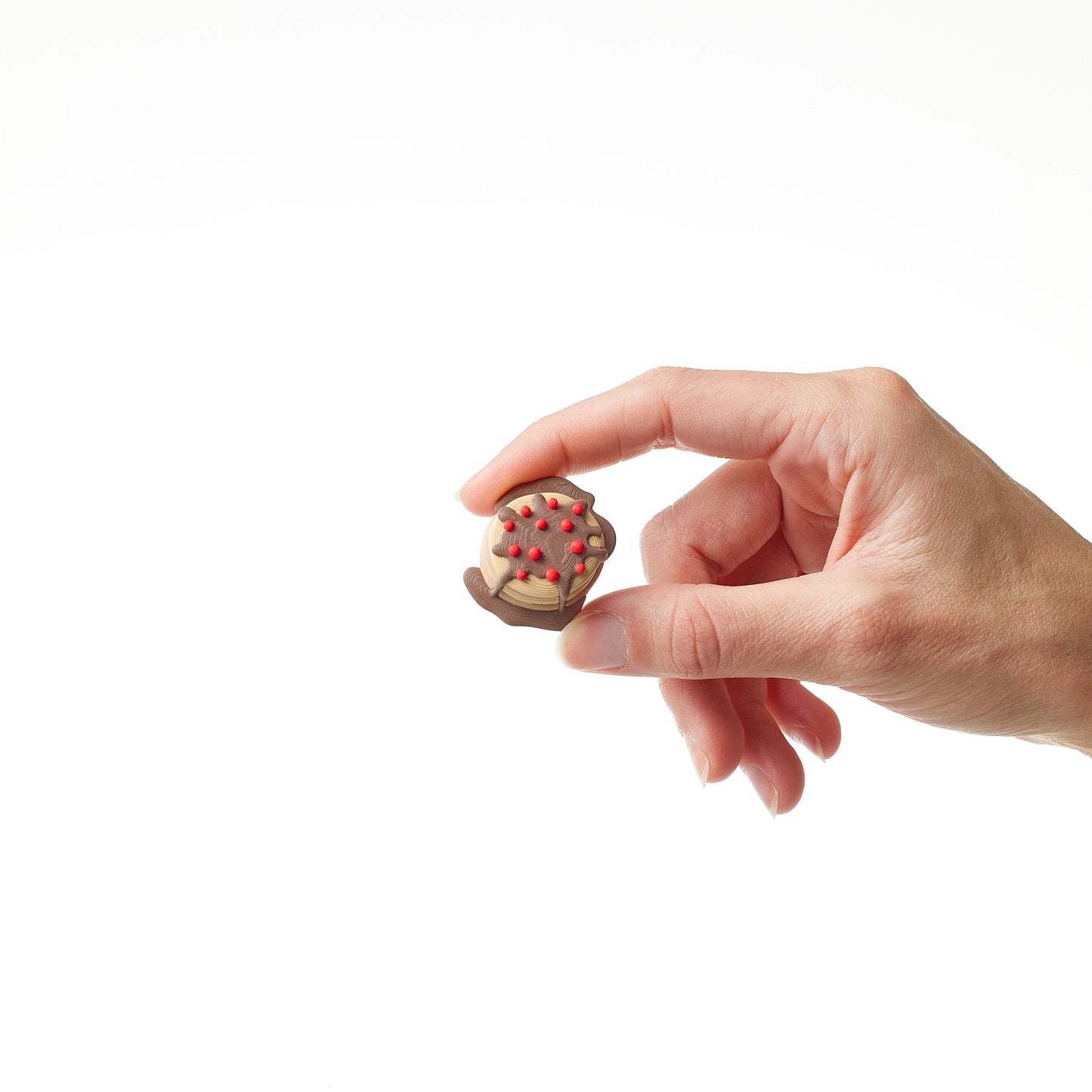 Pancake Topper in hand showing scale and size of pedal footswitch accessory
