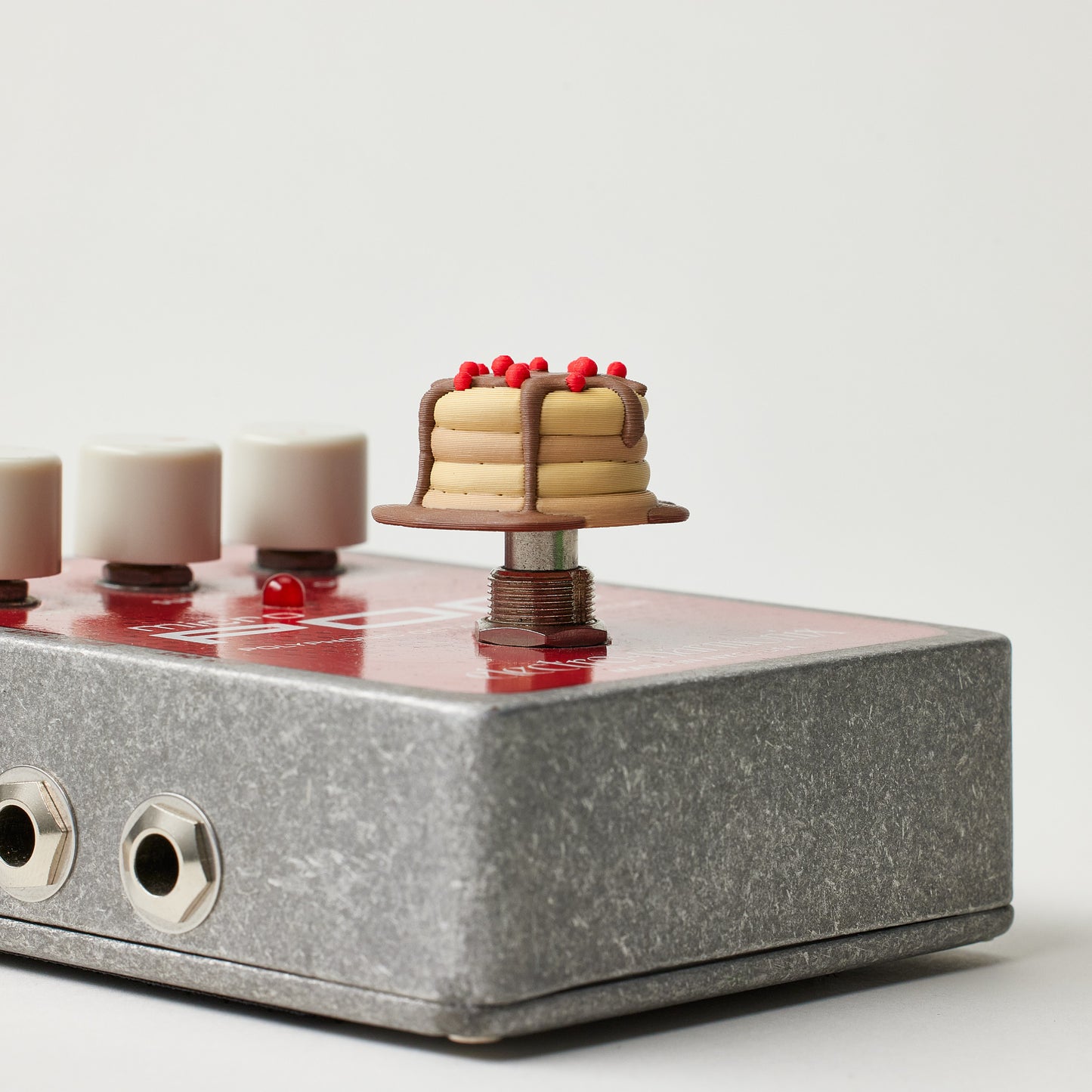 Pancake Topper installed on guitar effects pedal footswitch
