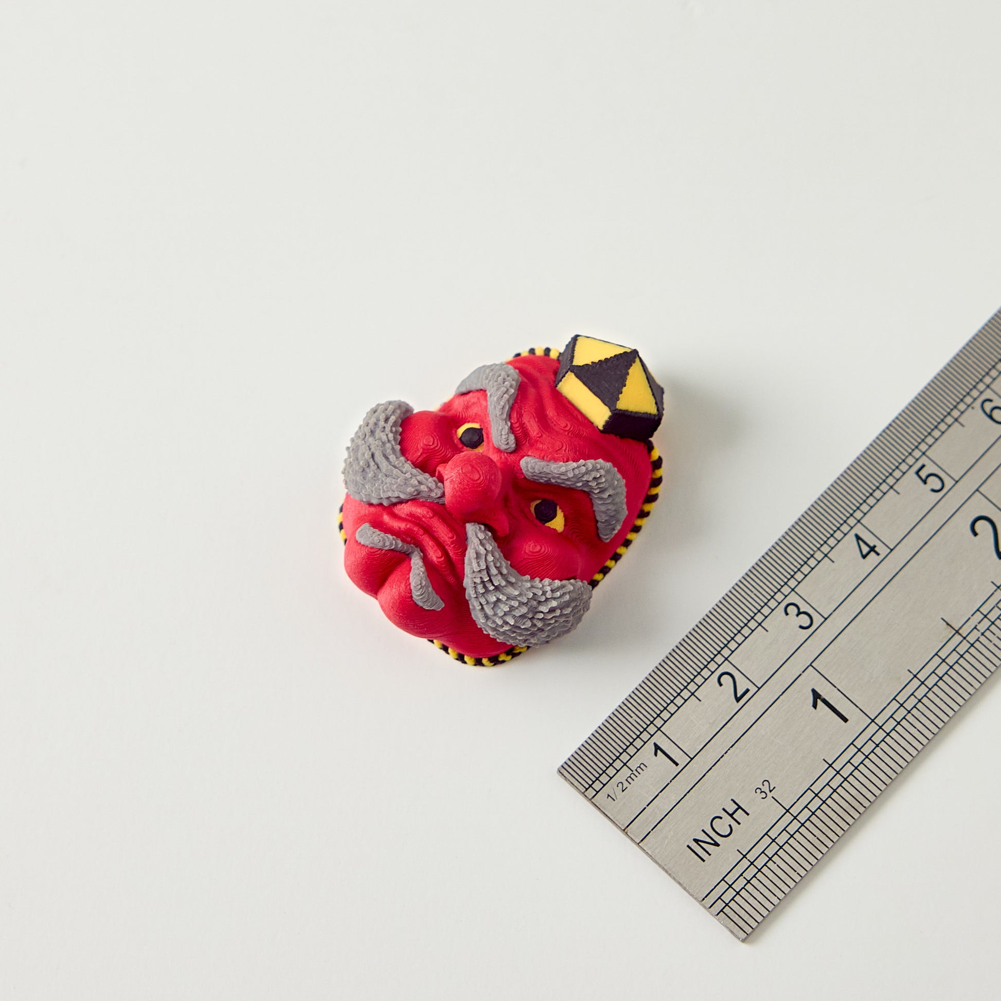 Tengu Topper — size reference with ruler showing Japanese demon mask topper dimensions for 10mm guitar effects pedal footswitch